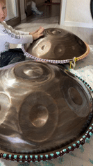 Toddler plays handpan drums at home in Tashkent