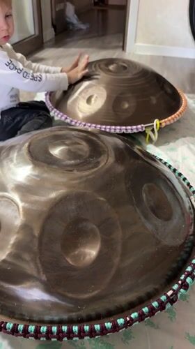 Toddler plays handpan drums at home in Tashkent