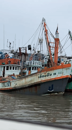Fishing boats moored at Ratsada harbor under gray skies