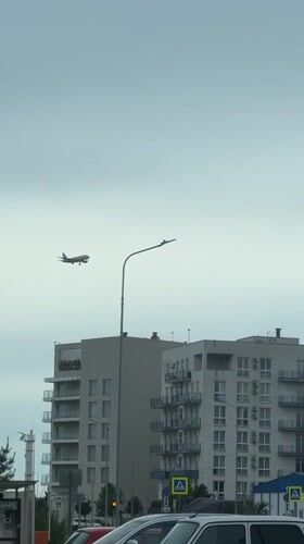 Passenger plane approaches landing over Sirius, Russia residential area