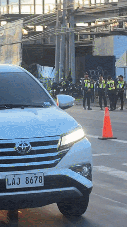 Police conduct traffic control operations at Davao City intersection