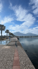 Woman records herself walking along waterfront path in Fethiye