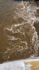 Turbulent water filmed near concrete pier in Chaikovsky, Russia