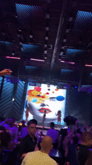 Woman in red beaded dress performs on nightclub stage
