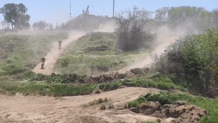 Dirt bike riders create dust clouds on Izmail track
