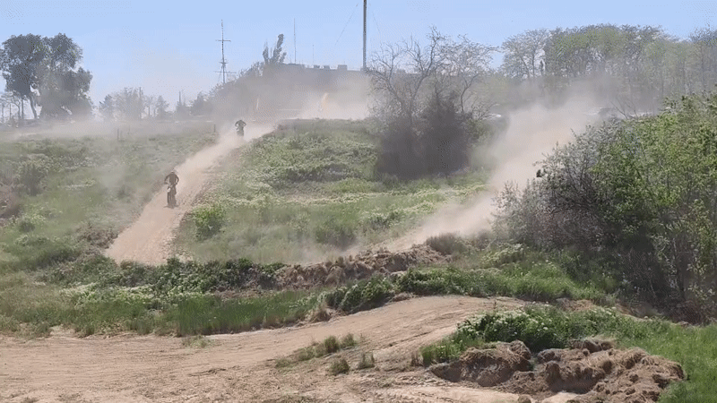 Dirt bike riders create dust clouds on Izmail track