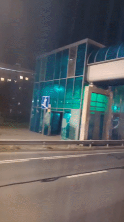 Night traffic and lit buildings along Klin streets
