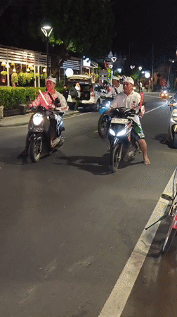 Traditional Balinese motorcycle procession observed in Denpasar evening