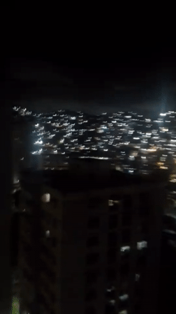 Caracas at night, city lights across hillsides and towers