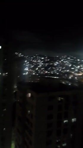 Caracas at night, city lights across hillsides and towers