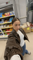 Woman shops for snacks and personal items in Moscow store