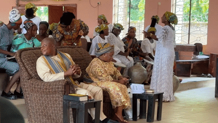 Formal community gathering in Hayin Banki with Nigerian flag on display