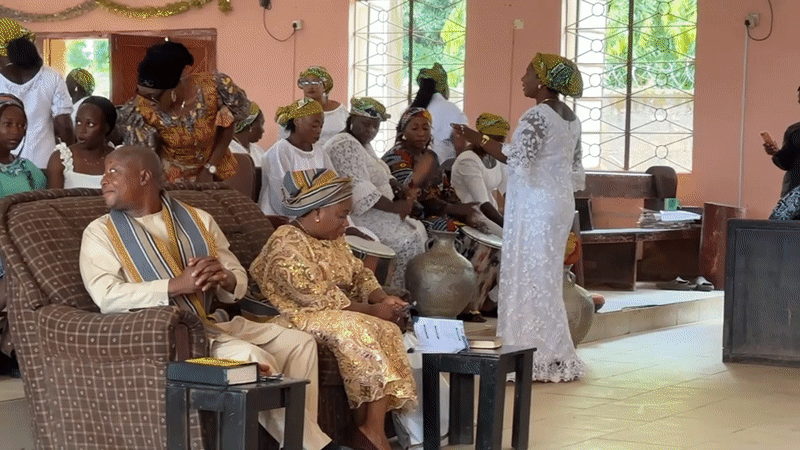 Formal community gathering in Hayin Banki with Nigerian flag on display