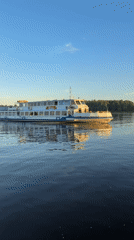 Woman films boat selfie during sunset in Rusanovo