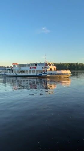 Woman films boat selfie during sunset in Rusanovo