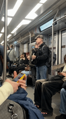 Street musician performs on Saint Petersburg subway during morning commute
