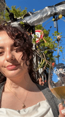Woman enjoys wine outdoors in sunny Amsterdam afternoon