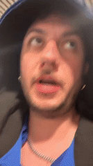 Tired traveler speaks to camera in London transport hub