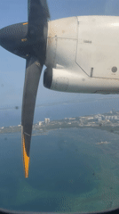 Passenger films turboprop engine view during flight over Philippines