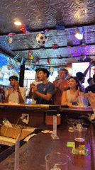 Soccer celebration at a flag-decorated New York bar