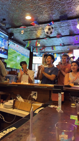Soccer celebration at a flag-decorated New York bar