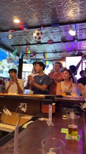 Soccer celebration at a flag-decorated New York bar