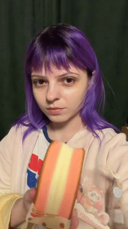 Purple-haired woman eats layered cake in Shchechenki, Russia