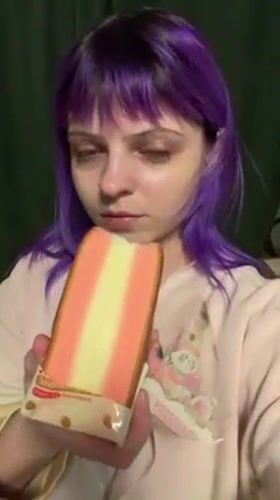 Purple-haired woman eats layered cake in Shchechenki, Russia