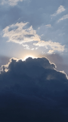 Dramatic sunlight breaks through dark clouds over Da Lat streets