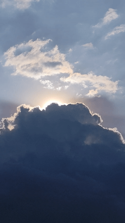 Dramatic sunlight breaks through dark clouds over Da Lat streets