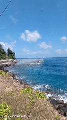 Turquoise reef break off a rocky Indonesian coastline