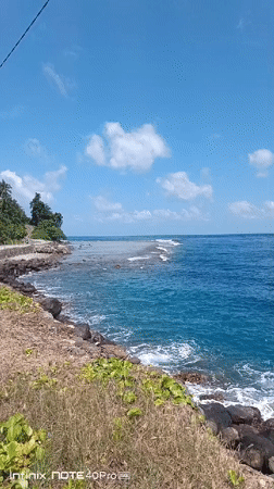 Turquoise reef break off a rocky Indonesian coastline
