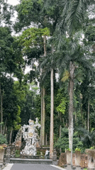 Early morning visitors explore temple grounds in Blahkiuh, Indonesia