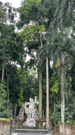 Early morning visitors explore temple grounds in Blahkiuh, Indonesia