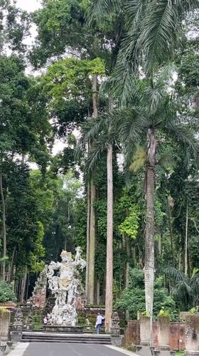 Early morning visitors explore temple grounds in Blahkiuh, Indonesia