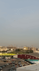 Dubai skyline shows ongoing construction with soccer field foreground