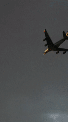 Aircraft spotted through cloudy skies over Delhi rooftops