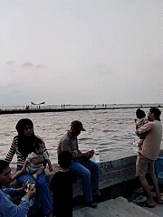 Serang waterfront buzzes with families, seafood stalls, and boats