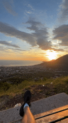 Person enjoys sunset view from bench in Montenegro