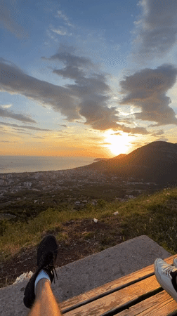 Person enjoys sunset view from bench in Montenegro