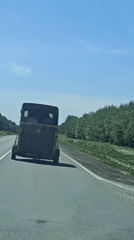Large trailer with yellow markings travels Russian highway