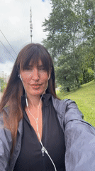 Casual sidewalk walk near a grassy hill in Moscow