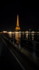 Electric scooter ride past the Eiffel Tower at night