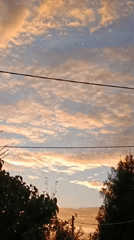 Sunset evening in a Verеya backyard: chickens, cyclists, golden sky