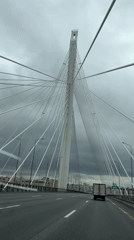 Vehicle crosses cable-stayed bridge in overcast Saint Petersburg