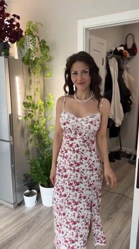 Woman in floral dress observed in Murino apartment