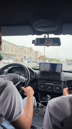 Two men travel by car in Parakar, Armenia