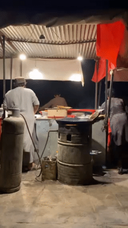 Evening food stall operates in Kandahar neighborhood