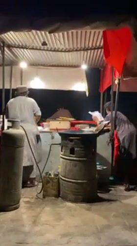 Evening food stall operates in Kandahar neighborhood