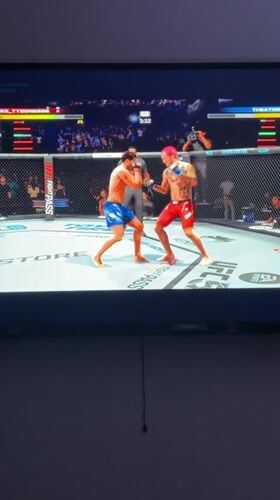 Person plays UFC video game in Arlington morning